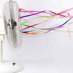 An electric fan with colorful ribbons