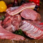 Raw pork over wooden background