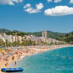 A crowd of vacationers enjoy the warm beaches of Costa Brava in Lloret de Mar.