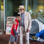 11-year-old Mikael talking to hunger striker Eduard Disch, at the building of the Immigration and Naturalization Service. 