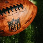 NEW YORK, USA, SEPTEMBER 11, 2023: NFL background photo. Ball placed on green grass in beautiful light.