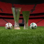 Image of the UEFA Europa League and UEFA Conference League trophies and ball.