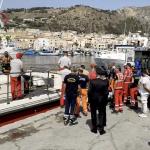 Emergency services crews await the return of divers and victims after a fatal incident where a yacht sank off Porticello in Italy. 19 August 2024