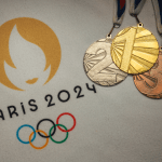 Gold silver and bronze medal on white blanket with official logo of Summer olympic game in Paris 2024