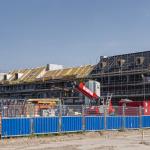 Houing construction in Amsterdam's Houthaven neighbourhood with construction tools in the foreground and homes in scaffolding in the back. 31 August 2019