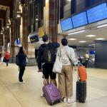 People with suitcases at Amsterdam Centraal trying to find information about their train. 5 September 2024
