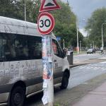 A van in a 30 km/h zone in Amsterdam slows down to let a woman cross Linnaeusstraat