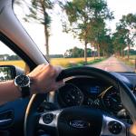 A driver behind the wheel of a Ford