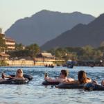 Tourists enjoying tubing in Song River in Vang Vieng, Laos