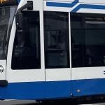 A tram heading west through the center of Amsterdam in 2024