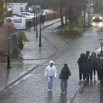 People on the street in Elburg, Gelderland, as rain showers pass by with a stiff wind. 27 Nov. 2024