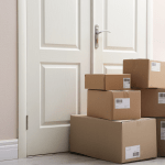 A pile of parcels stacked outside a door