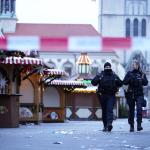 Police officers patrol a cordoned-off area at a Christmas Market, where a car drove into a crowd on Friday evening, in Magdeburg, Germany, Saturday, Dec. 21, 2024