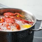 Crabs and lobsters boiling in water