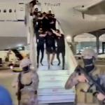 Isaac B. led off an airplane by police in Turkey. July 2023