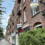 A woman walks by two homes for sale on the Javastraat in Amsterdam-Oost in July 2023.