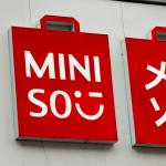 The logo for discount retail chain Miniso above a store front