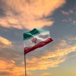 Iranian flag flying on a pole.