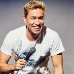 Russell Howard performing comedy on stage 
