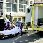 A victim of a stabbing with multiple injuries at Dam Square is helped by ambulance workers.