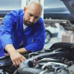 A mechanic fixing a car in a service garage