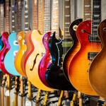 A row of acoustic and electric guitars.