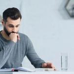A worried man is doing taxes