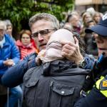 Police remove pro-Palestinian activists at the start of the National Liberation Day Celebration in Wageningen, Netherlands, Sunday, May 5, 2025.