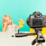 Girl speaking in front of camera for a vlog.