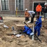 IDDS archaeologists excavate an earthenware pot that was buried under a floor.