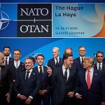 NATO Secretary General Mark Rutte pointing past a grinning Dutch Prime Minister Dick Schoof while speaking with U.S. President Donald Trump at the start of the NATO Summit in The Hague. 24 June 2025