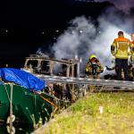 Firefighters at a fire on a houseboat on Goirkekanaaldijk in Tilburg in which one person died, 17 June 2025