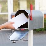 Taking letters from a mailbox.