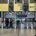 Travelers walk through the access gates in the newly reopened western passenger tunnel on the city center side of Amsterdam Centraal Station, June 2, 2025.