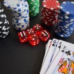 Playing cards, dice, and casino chips on a tabletop