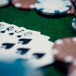 A royal flush laid out on a poker table surrounded by casino chips