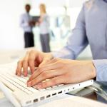 A man is typing something at work