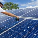 Worker is installing solar panels