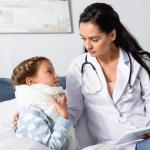 A doctor is treating a sick child at home.