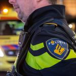 A police officer with an ambulance in the background