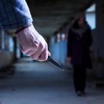 A man with a knife approaches a woman in a visual representation of femicide.