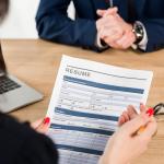 A recruiter holding a candidate's resumé 