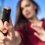 Young woman protecting herself with the help of pepperspray.
