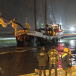 People await the sailing charter Storebaelt at the Harlingen port after it collided with a freighter on the Wadden Sea with 25 German school children on board, 14 September 2025