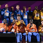 Dutch relay athletes Nsikak Ekpo, Taymir Burnet, Xavi Mo-Ajok, and Elvis Afrifa (in orange) alongside other runners at the 2024 relay event in Rome.