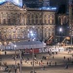 People pose in front of the “I Amsterdam” sign placed at Dam Square in front of a special polling place set up for the Tweede Kamer election outside of the Royal Palace. The “I” was replaced by a statue of the red pencil voters are given when to mark their ballots. 29 October 2025