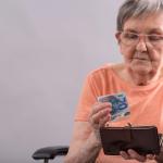 Elderly woman is counting money