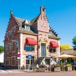 People on outdoor terrace of cafe in old town hall of Laren, Noord-Holland