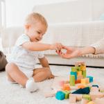 A toddler is playing with cubes