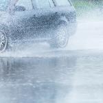 Car rides through a big puddle